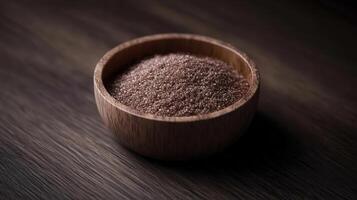 Psyllium husk in a wooden bowl on a dark surface photo