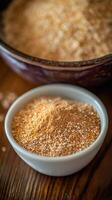 Psyllium powder displayed in a small bowl on wooden surface photo
