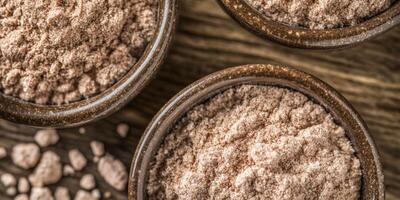 Psyllium husk powder in rustic bowls on a wooden surface photo