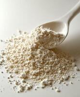 Psyllium powder displayed on a wooden spoon for use photo