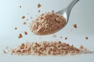 Spoonful of psyllium powder on a neutral backdrop photo