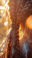 Boho braids styled with feathers at sunset photo