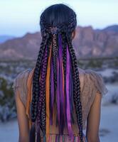 Boho braids with colorful ribbons in desert landscape photo