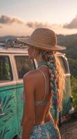 A woman with long braids and a hat standing next to a van photo