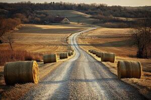 Rolling hills and hay bales on a quiet rural road photo