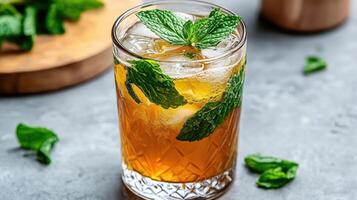 Refreshing mint tea in clear glass with ice and mint leaves photo