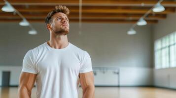 man in sports facility looks up thoughtfully, showcasing determination photo