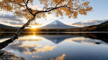 Majestic Mount Fuji reflected in serene lake at sunrise, surrounded by autumn foliage photo