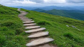 Scenic view of winding stone path through lush green hills and mountains photo