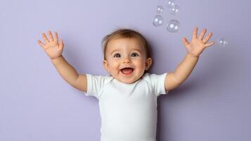 A baby is playing with soap bubbles photo