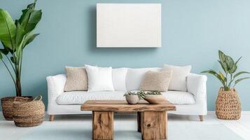 A white couch and a wooden table in front of a blue wall photo