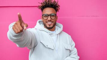 A man with dreadlocks pointing at something photo
