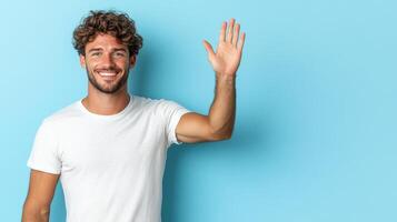 Smiling man waving his hand in front of blue background photo