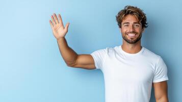 Smiling man waving his hand over blue background photo