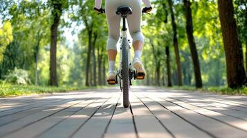 Cyclist riding mountain bike on wooden path in green park photo
