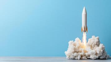 single rocket launching with smoke and flames against blue background photo