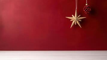 single star ornament and red berries hanging on deep red wall photo