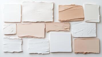 Textured paint samples in neutral tones arranged on white background photo