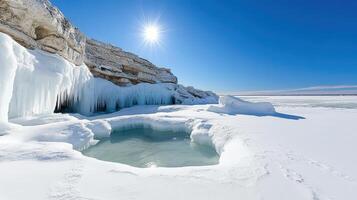 stunning winter landscape featuring icy shoreline and clear blue sky photo