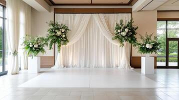 Elegant white curtain backdrop with floral arrangements for events photo