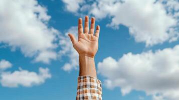 hand reaching for sky, symbolizing hope and aspiration photo
