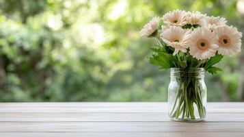 Freshly cut flowers in glass vase on wooden table, creating serene atmosphere photo