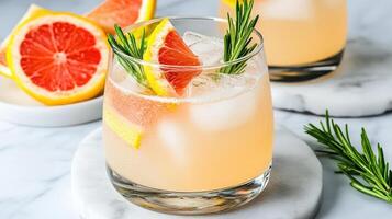 Freshly made cocktails with citrus garnishes and rosemary sprigs photo