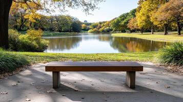 tranquil park scene featuring autumn foliage, serene lake, and wooden bench photo