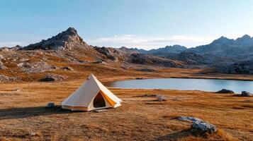 rugged landscape with single tent by serene lake, symbolizing solitude photo