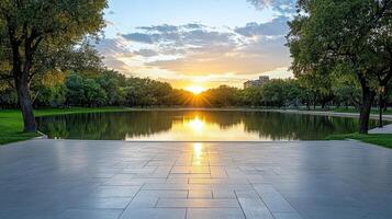 Sunset over tranquil city park pond reflecting vibrant colors photo