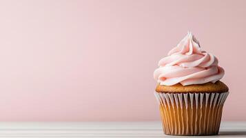 Delicious cupcake with pink frosting on pastel pink background photo