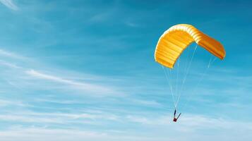 yellow parachute gliding gracefully against clear blue sky photo