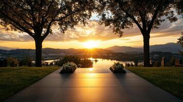 serene sunset over cemetery with silhouettes of trees and mountains photo