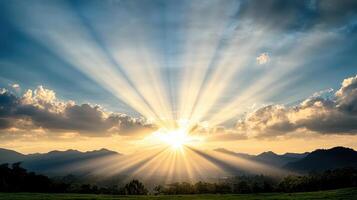Breathtaking sunrise with rays of light illuminating mountains and sky photo