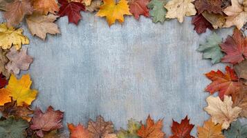 Autumn leaves in vibrant colors framing textured background photo