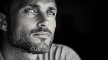 A black and white photo of a man with a beard
