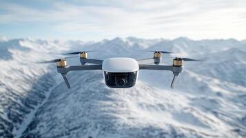 A white drone flying over a snowy mountain range photo