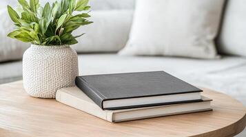 Elegant photo albums on wooden table with decorative plant