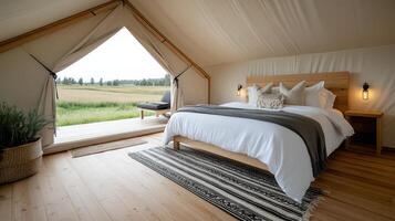 A bedroom with a bed and a window overlooking a field photo