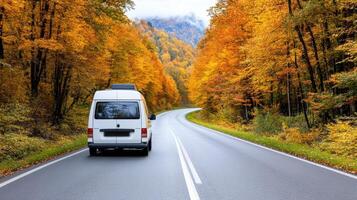 A white van driving down a road in the fall photo