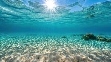 Underwater view of the sun shining over the ocean photo