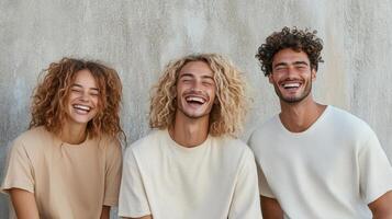 Happy models with curly hair posing together against textured wall photo