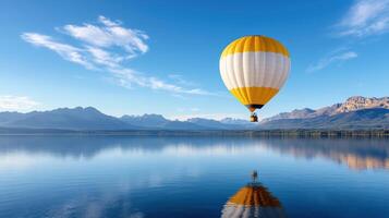 lone hot air balloon floats over serene lake, reflecting mountains photo