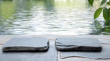 Serene spa scene with hot stone therapy stones by tranquil water surface photo