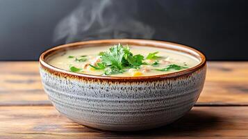 steaming bowl of vegetable soup garnished with fresh herbs photo