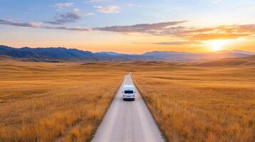 long winding road through golden fields at sunset creates serene atmosphere photo