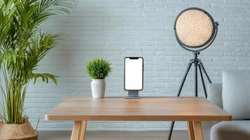 modern desk setup featuring smartphone, plant, and stylish lamp photo
