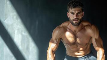 A shirtless man is posing for a photo