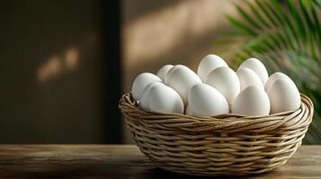 White eggs in a basket on a table photo