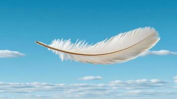 delicate feather floating gracefully in clear blue sky photo